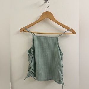 Light green/minty sleeveless top with matching pants.